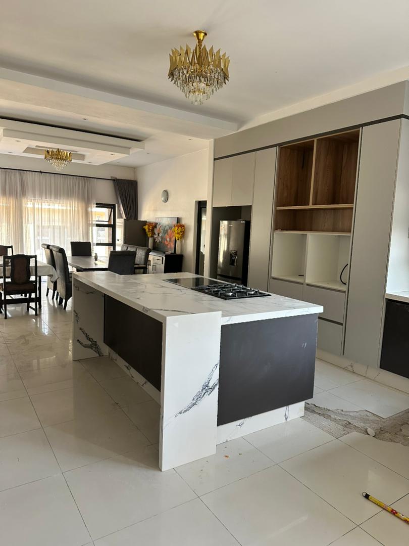 Bespoke fitted kitchen with marble waterfall island by The Stone Lab Company